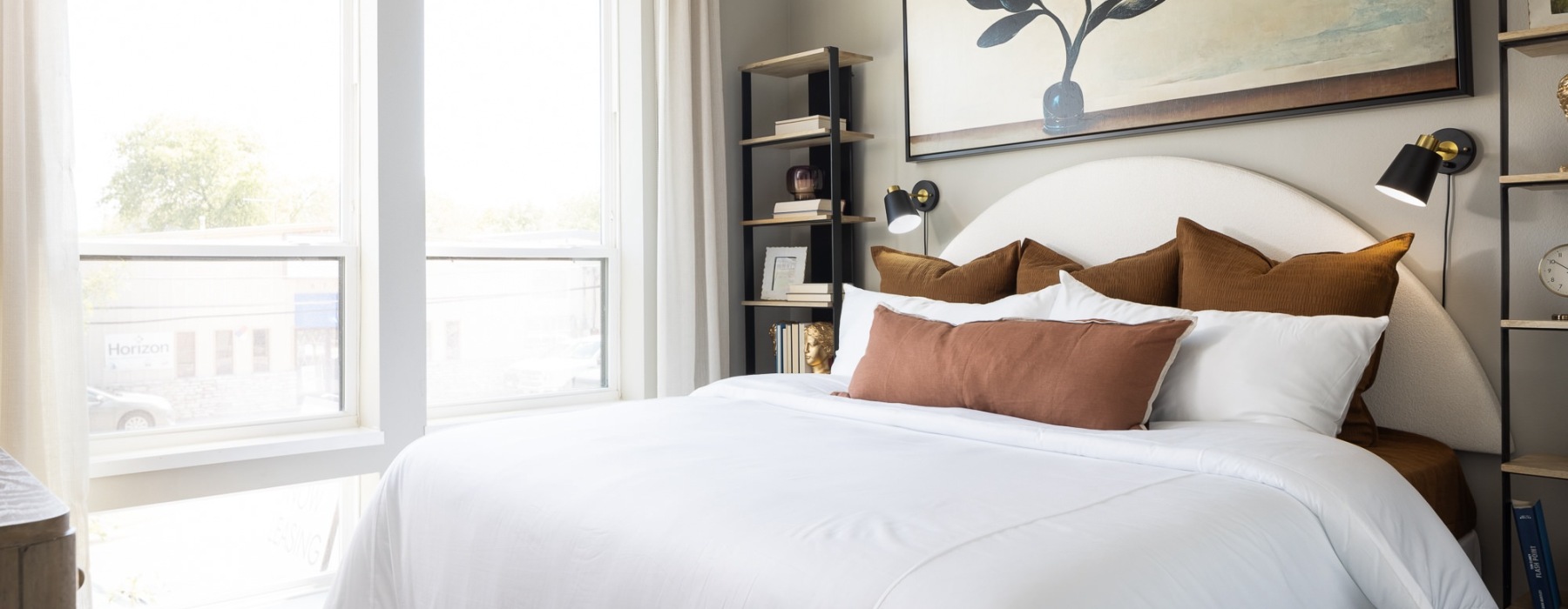 bedroom with large window and bed