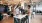 a group of people standing around a table with a laptop